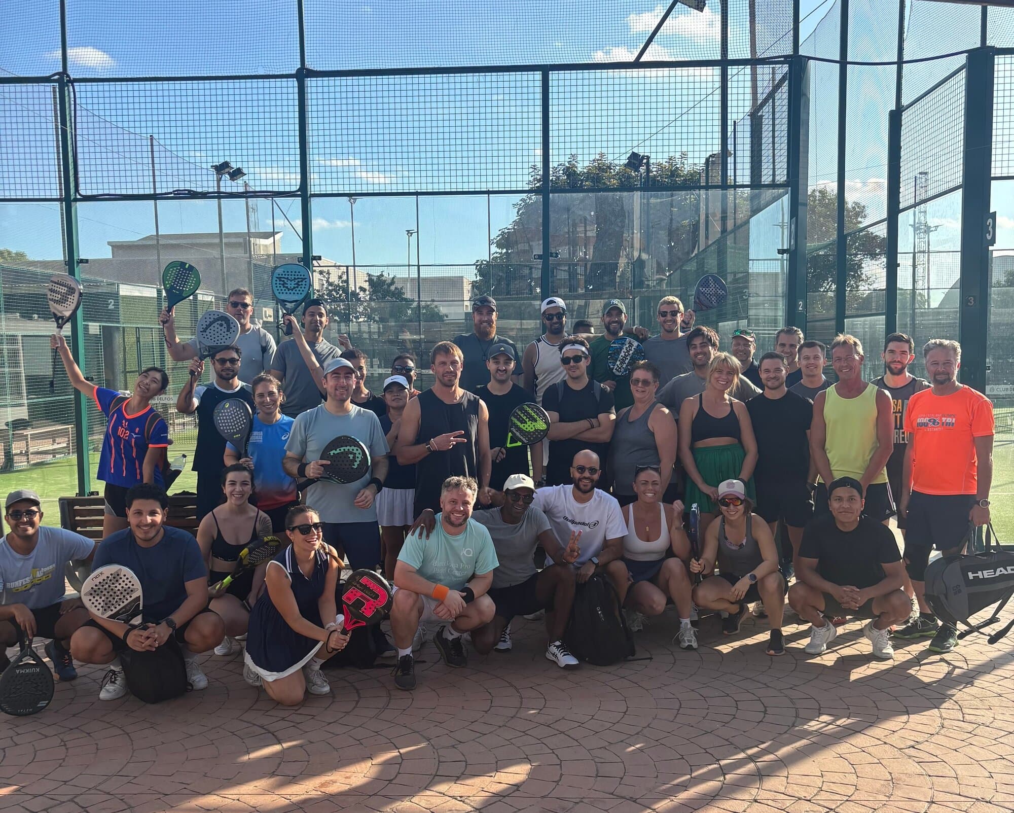 Large group of Keep Calm padel players celebrating a Padel Americana night at Club Delfos, Barcelona