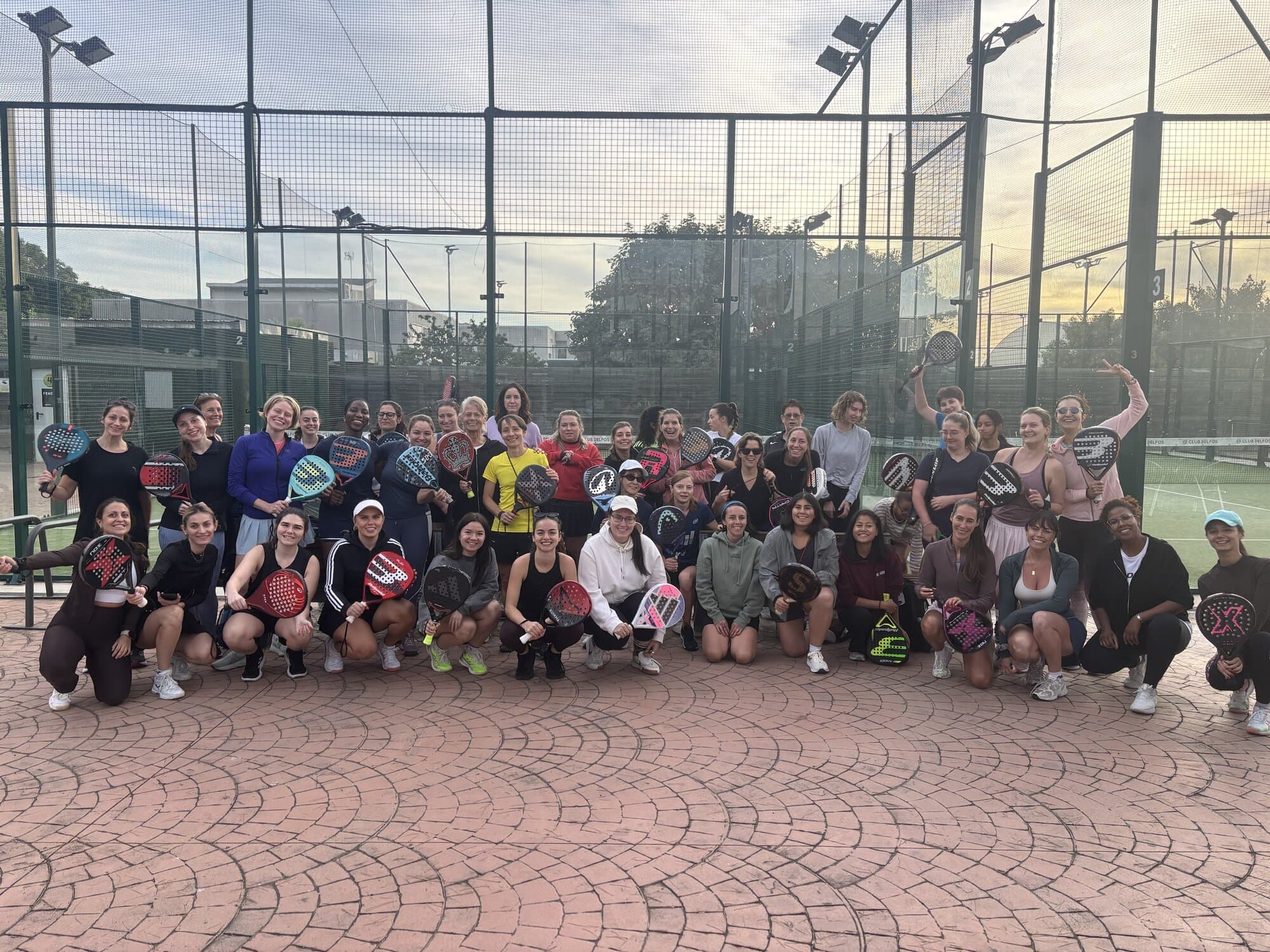 Group photo of women holding padel rackets at the end of Keep Calm's Women's Americana, Keep Calm Community Barcelona