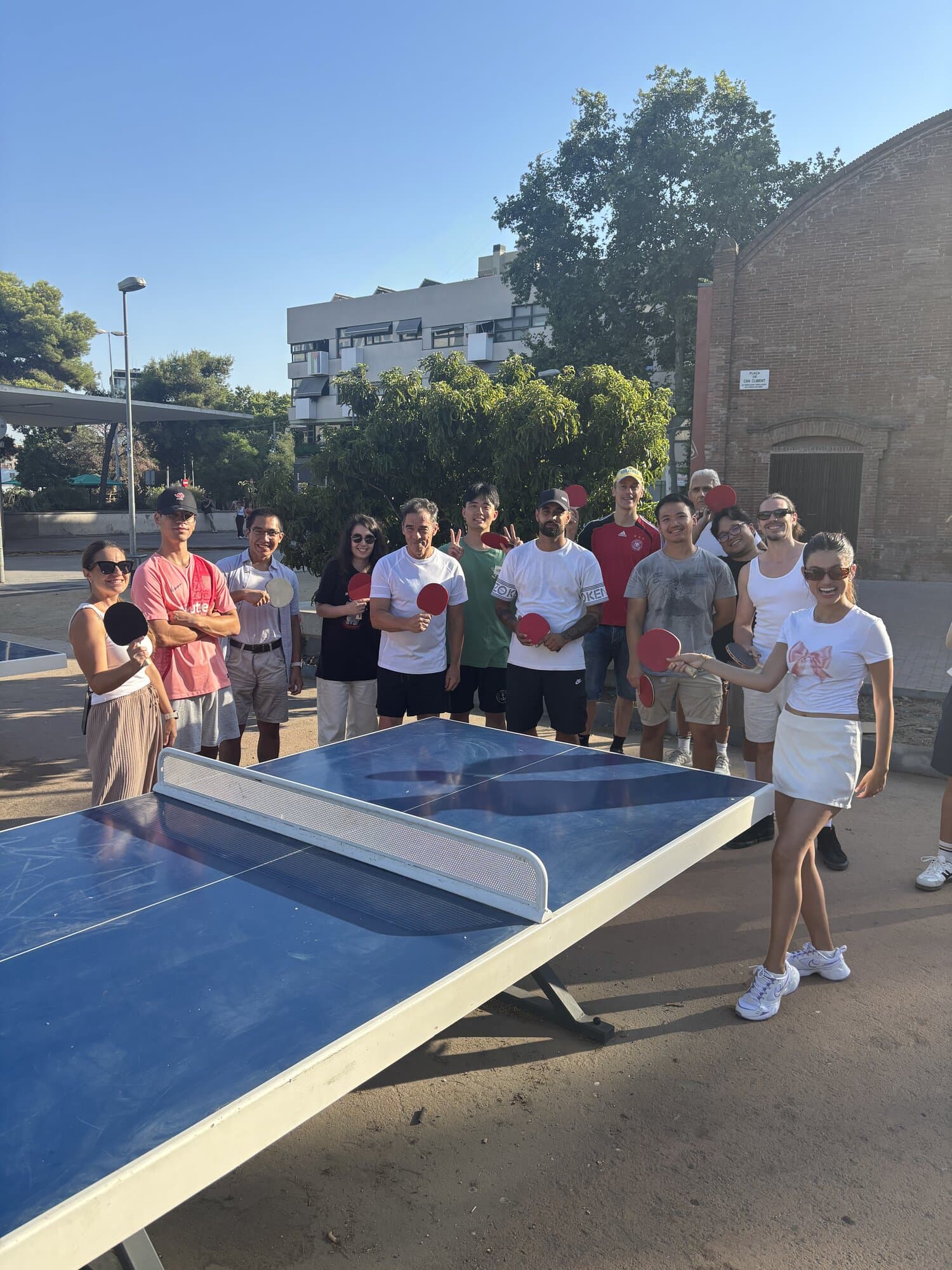Keep Calm Community table tennis group holding paddles at Thursday session in Sants, Barcelona