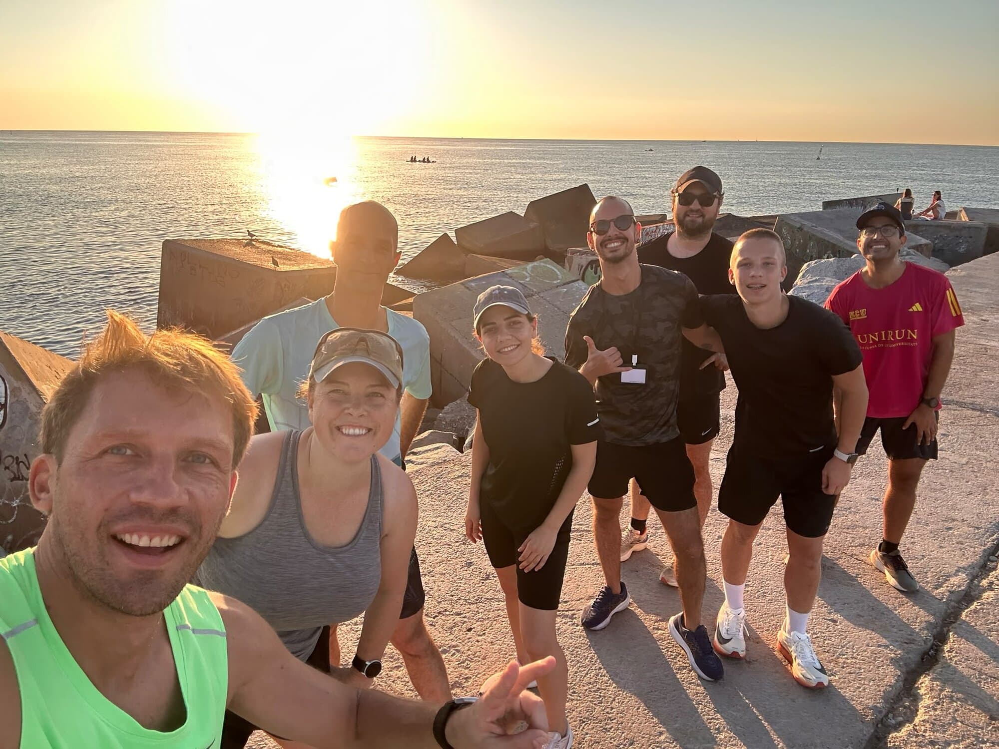 Keep Calm Community sunrise run and swim group on the Barceloneta breakwater