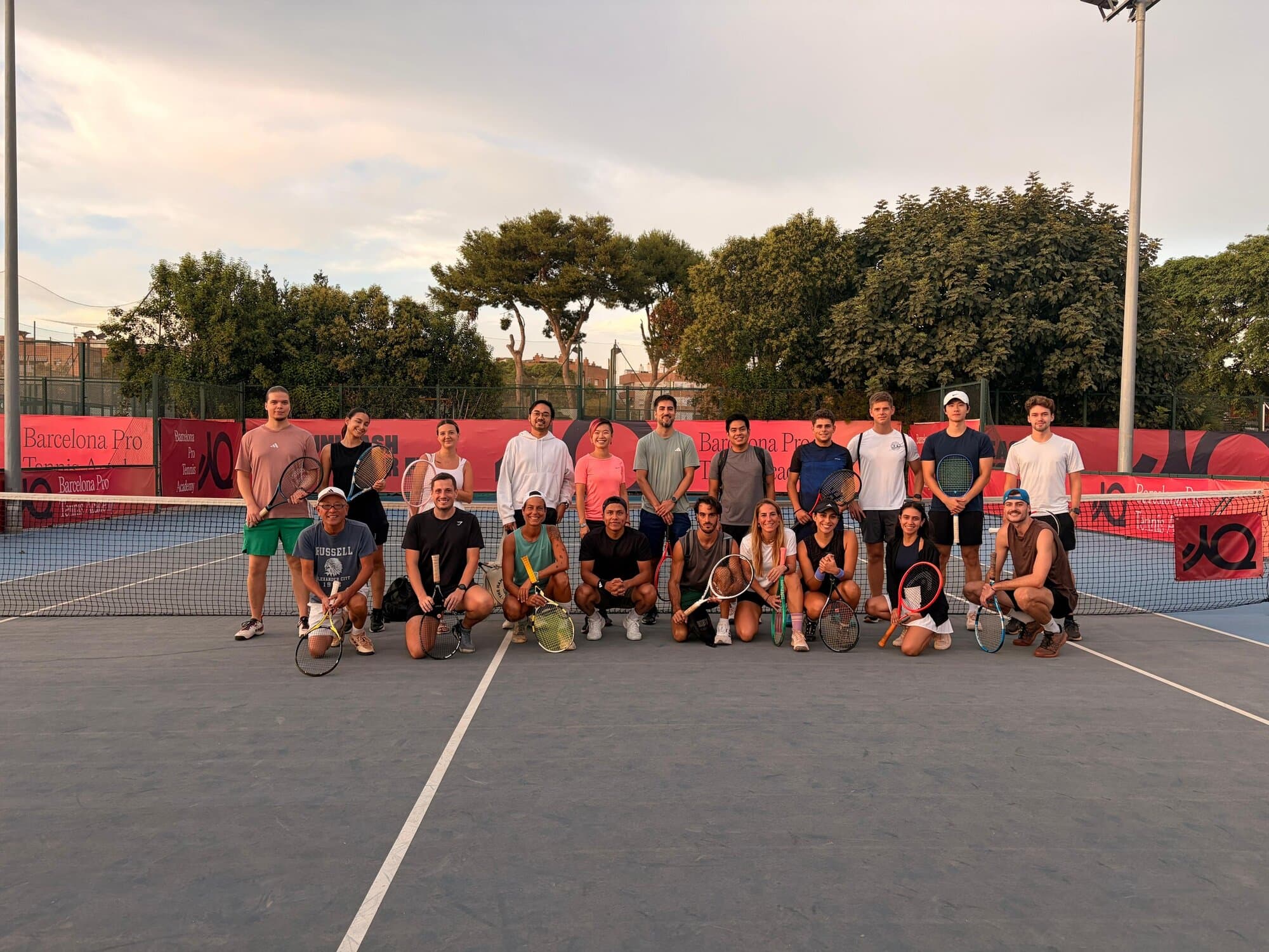 Keep Calm Community Barcelona tennis group photo on the clay courts at Barcelona Pro Tennis Academy