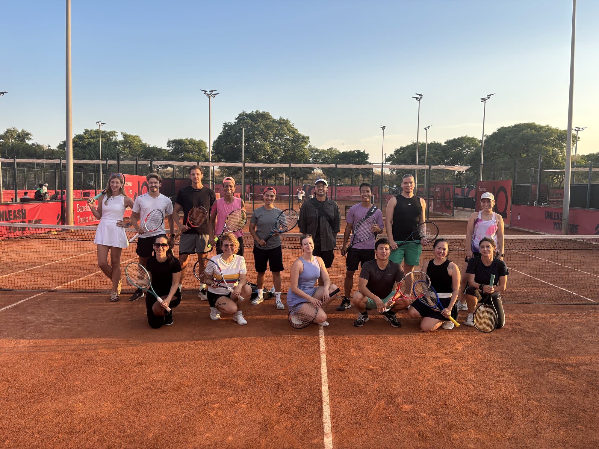 Keep Calm Community tennis group on a clay court in Barcelona