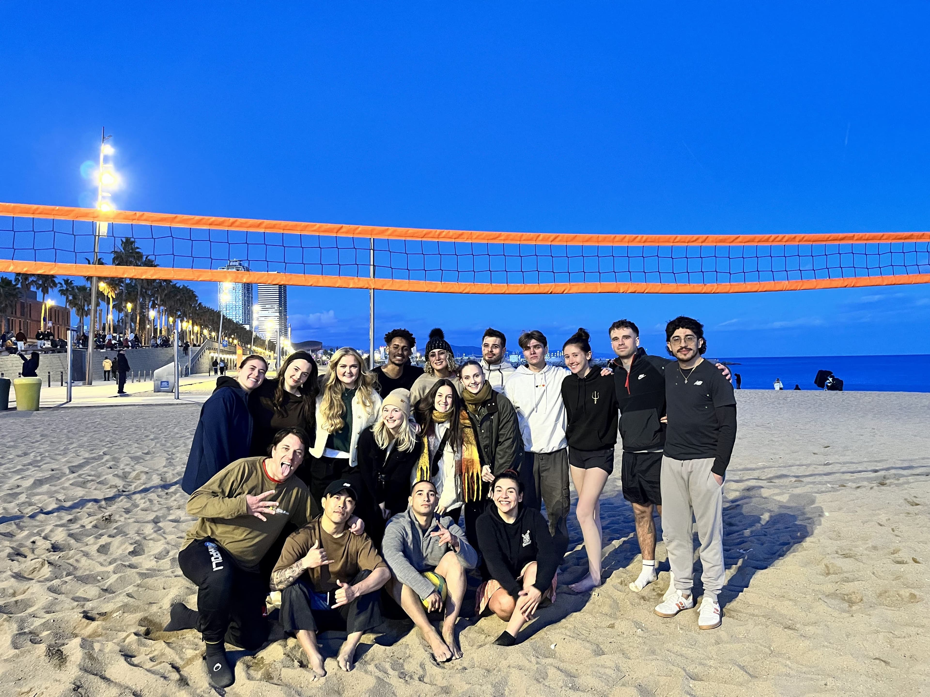 Women playing beach volleyball at sunset in Barcelona