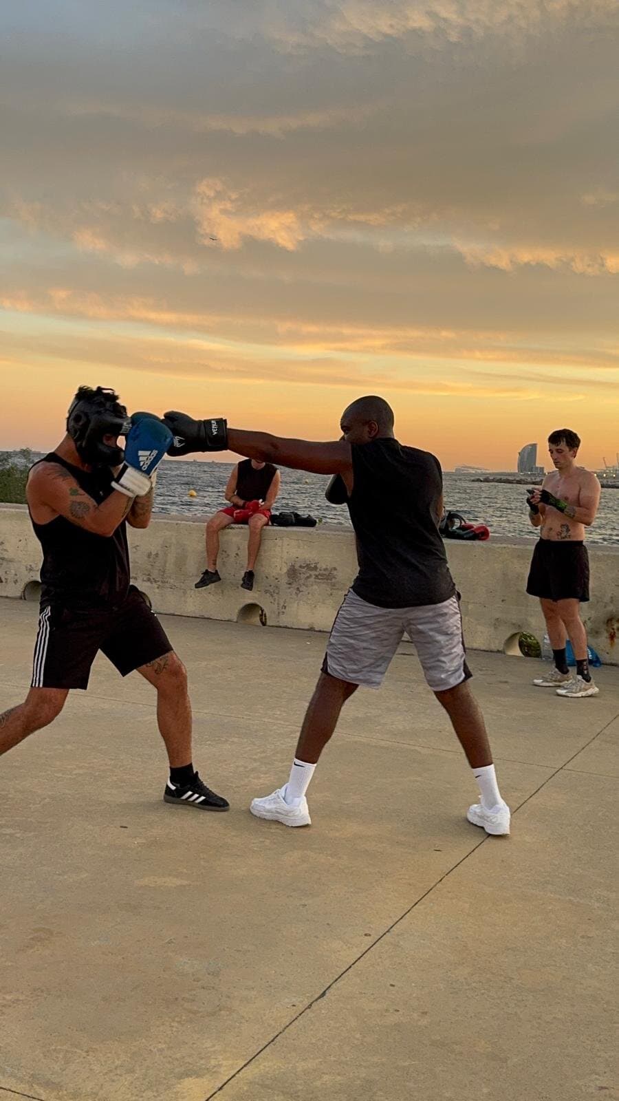 Keep Calm Community Barcelona boxing sparring session at sunset on the Barceloneta seafront with the W Hotel in the background